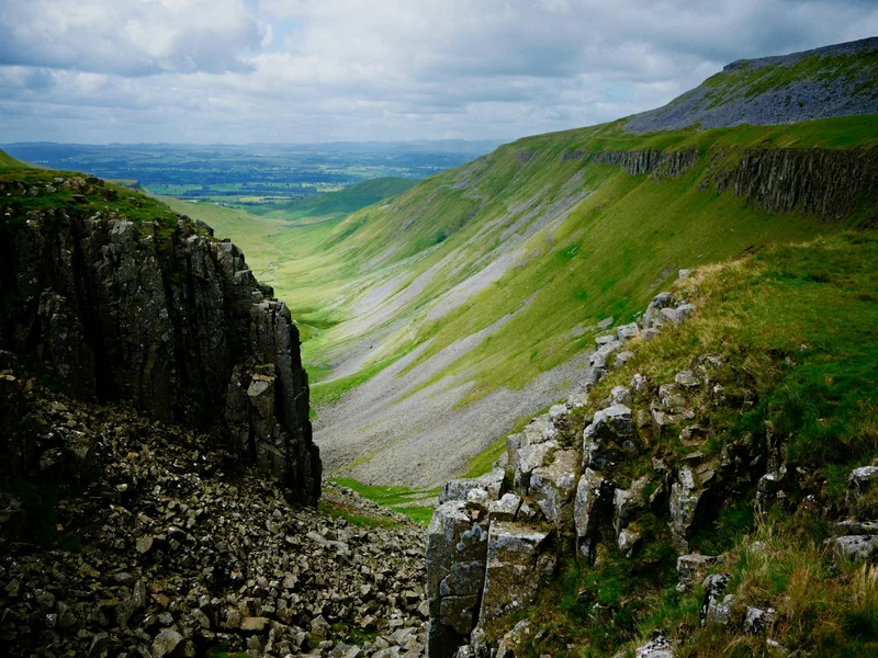 Green and Brown Mountain Under White Clouds During Daytime